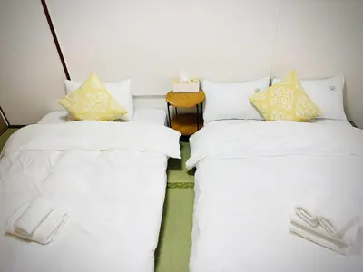 two beds sitting next to each other in a room at \u685cHome in Tokyo