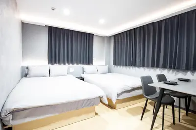 a hotel room with two beds and a table at Walk to Kuramae Subway Stop YoYK in Tokyo