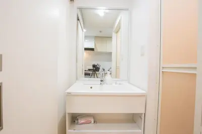 a bathroom with a sink and a mirror at Walk to Kuramae Subway Stop YoYK in Tokyo