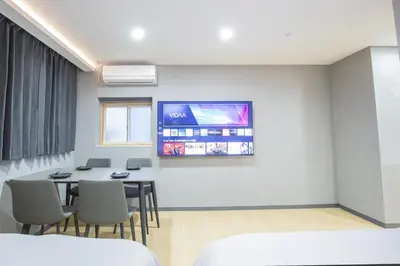 a room with a table and a tv on the wall at Walk to Kuramae Subway Stop YoYK in Tokyo
