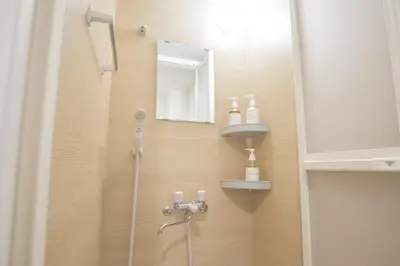 a bathroom with a shower with a sink and a mirror at Walk to Kuramae Subway Stop EoYi in Tokyo