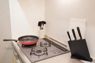 a pot on a stove in a kitchen at Walk to Kuramae Subway Stop EoYi in Tokyo