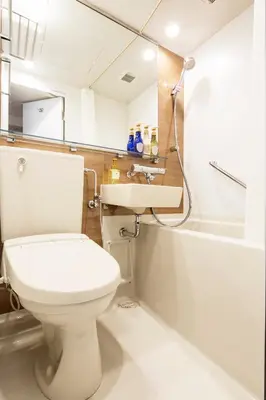 a bathroom with a toilet and a sink and a shower at Hotel Mystays Gotanda Station in Tokyo