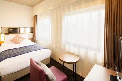 a hotel room with a bed and a window at Hotel Mystays Gotanda Station in Tokyo