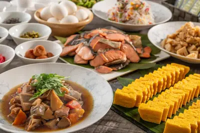 a table with plates of food and bowls of food at Hotel Mystays Gotanda Station in Tokyo
