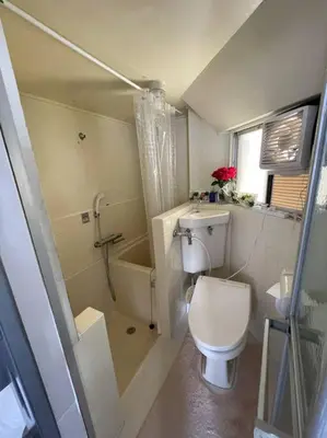 a small bathroom with a toilet and a shower at Local Stay NAKAI in Tokyo