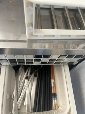 an open refrigerator drawer filled with lots of utensils at Local Stay NAKAI in Tokyo