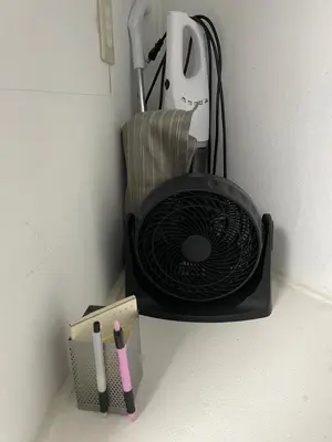 a holder with a fan and pens in a wall at Local Stay NAKAI in Tokyo
