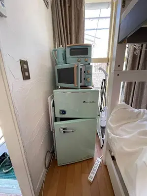 a room with a tv on top of a refrigerator at Local Stay NAKAI in Tokyo