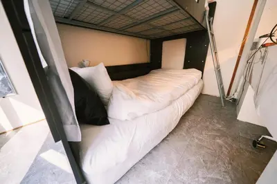 a room with a white bed with pillows at Akasaka Central Hostel Roppongi Akasaka in Tokyo