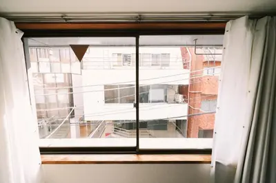a window with a view of a building at Akasaka Central Hostel Roppongi Akasaka in Tokyo