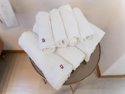a pile of towels sitting on top of a table at Shinjuku, Hatsudai Sta 7min walk,PS5,Switch,Wi-Fi in Tokyo