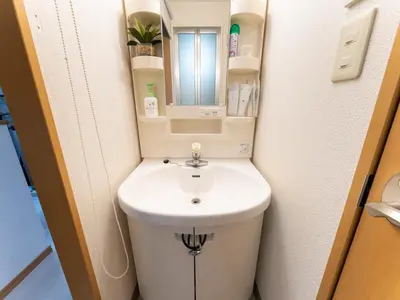 a small bathroom with a toilet and a sink at Shinjuku, Hatsudai Sta 7min walk,PS5,Switch,Wi-Fi in Tokyo