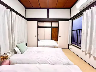 two beds in a room with two windows at AX-Ojima House-KT0175 in Tokyo