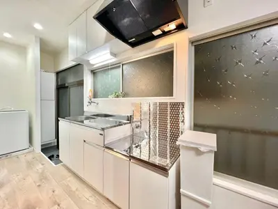 a kitchen with white cabinets and a microwave at AX-Ojima House-KT0175 in Tokyo