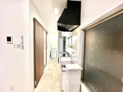 a bathroom with a long hallway with sinks and a mirror at AX-Ojima House-KT0175 in Tokyo