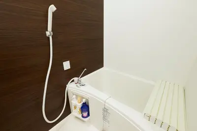a washing machine with a cord attached to a wall at Fiore Kinshicho by Tranova in Tokyo