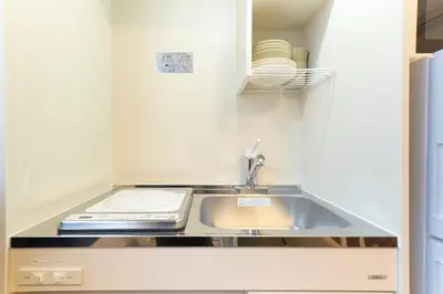 a kitchen with a sink and a stove at Fiore Kinshicho by Tranova in Tokyo