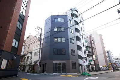 a tall blue building on a city street at Fiore Kinshicho by Tranova in Tokyo