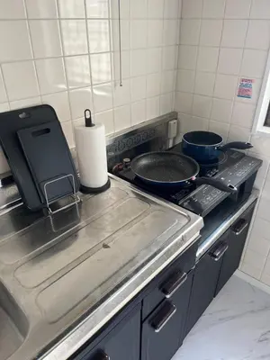 a kitchen with a stove with a pan on it at ATW Tokyo Near the station Close to Asakusa Airport For infants and toddlers in Tokyo