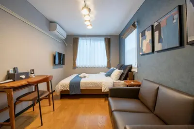 a bedroom with a bed and a desk and a couch at SR corpo in Tokyo