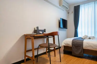 a room with a desk and a bed and a desk with a chair at SR corpo in Tokyo