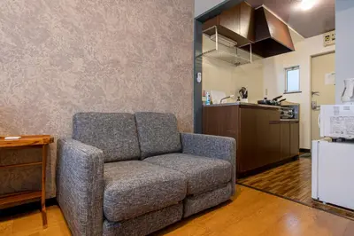 a living room with a couch and a kitchen at SR corpo in Tokyo