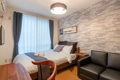 a bedroom with a bed and a chair and a couch at SR corpo in Tokyo