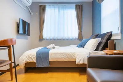 a bedroom with a large bed with a window at SR corpo in Tokyo