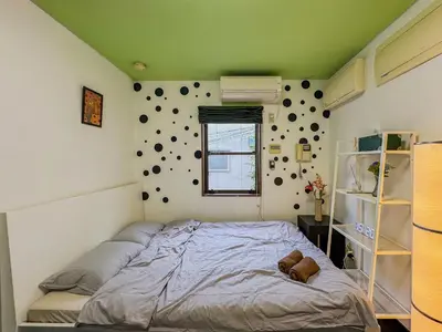 a bedroom with a bed with a teddy bear on it at Tranquil Tokyo Retreat #Spacious 3BR House in Hiroo in Tokyo