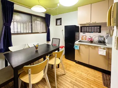 a kitchen and dining room with a black table and chairs at Tranquil Tokyo Retreat #Spacious 3BR House in Hiroo in Tokyo