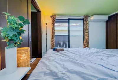a bedroom with a bed with a stuffed animal on it at Tranquil Tokyo Retreat #Spacious 3BR House in Hiroo in Tokyo