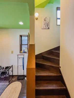 a staircase in a house with wooden floors and green ceilings at Tranquil Tokyo Retreat #Spacious 3BR House in Hiroo in Tokyo