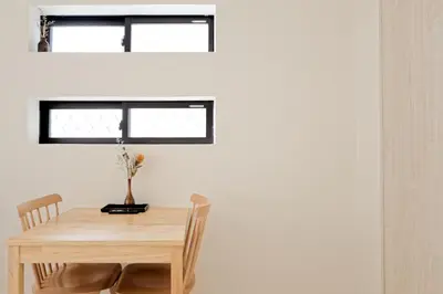 a table and chairs in a room with a window at Mi-HOTEL CALM RIVERSIDE in Tokyo