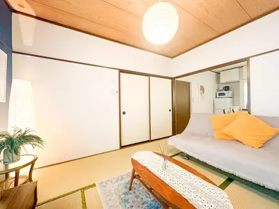 a room with a bed and a couch and a table at Shinkoiwa Stay, Private House, Nearby Station, Good access to Ueno&Asakusa in Tokyo