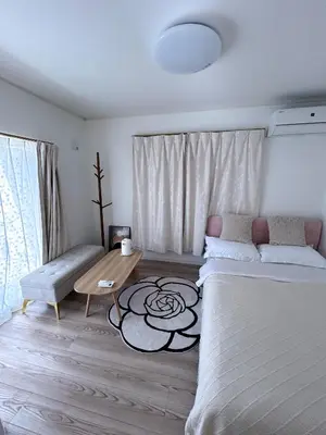 a bedroom with a bed and a table and a couch at Sunflower \u6c11\u6cca in Tokyo