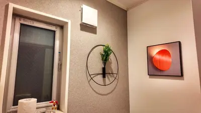 a bathroom with a plant in a circle on the wall at Sunflower \u6c11\u6cca in Tokyo