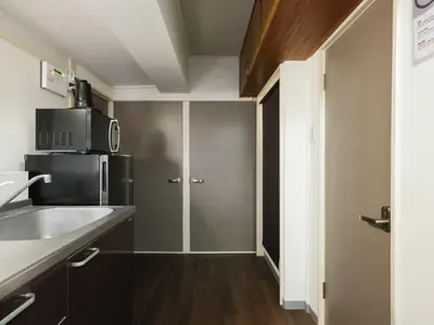 a small kitchen with a sink and a microwave at Hatagaya heim 403 in Tokyo