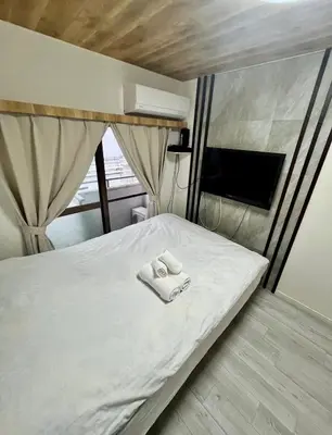 a bedroom with a bed with two towels on it at fukuhana\u6771\u65b0\u5bbf in Tokyo
