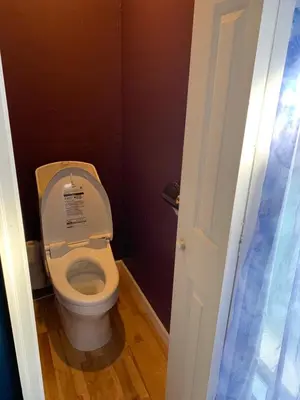 a bathroom with a toilet with the lid up at The Standard Apartment SHIBUYA SASAZUKA Room K in Tokyo