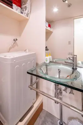 a bathroom with a sink and a mirror at Shirokane Apartment Hotel 2 in Tokyo