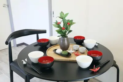 a black table with bowls and utensils on it at \u30b5\u30f3\u30cf\u30a4\u30c4\u521d\u53f0 201 in Tokyo