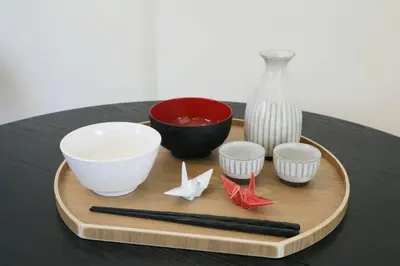 a wooden tray with bowls and a vase and chopsticks at \u30b5\u30f3\u30cf\u30a4\u30c4\u521d\u53f0 201 in Tokyo