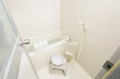 a small white bathroom with a toilet in it at \u30b5\u30f3\u30cf\u30a4\u30c4\u521d\u53f0 201 in Tokyo