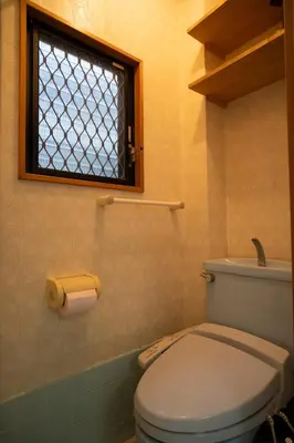 a bathroom with a toilet and a window at Miyabi Inn-Kameido in Tokyo