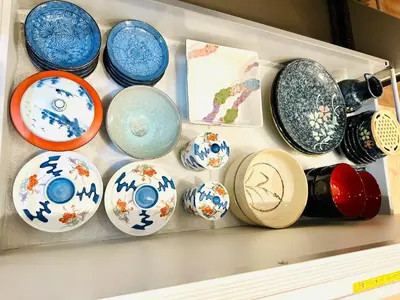 a drawer filled with blue and white ceramics at MoRi House IN西日暮里Ⅱ in Tokyo