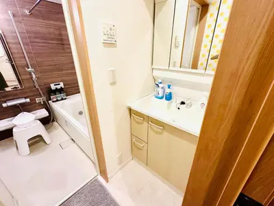 a bathroom with a sink and a toilet and a mirror at MoRi House IN西日暮里Ⅱ in Tokyo