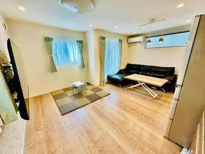 a living room with a couch and a table at MoRi House IN西日暮里Ⅱ in Tokyo