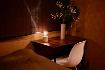 a small table with a candle and a chair at ICHINAGI Yanaka Luxury Villa near Asakusa in Tokyo