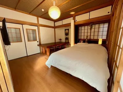 a bedroom with a white bed and a desk at ICHINAGI Yanaka Luxury Villa near Asakusa in Tokyo